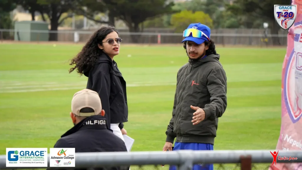 Two crew members talking on the field during a match