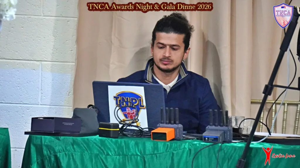 Crew member at the streaming desk with laptop and switching gear at a gala dinner