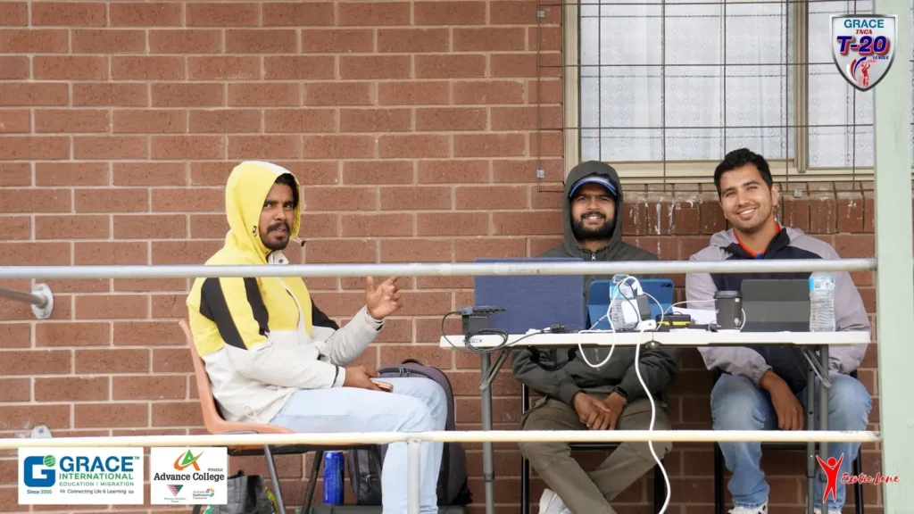 Three crew members at the production desk with laptops at the ground