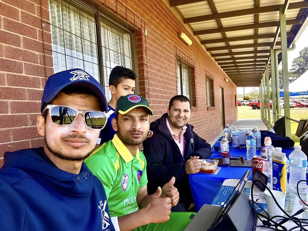 Crew selfie at the streaming desk with laptops at the ground
